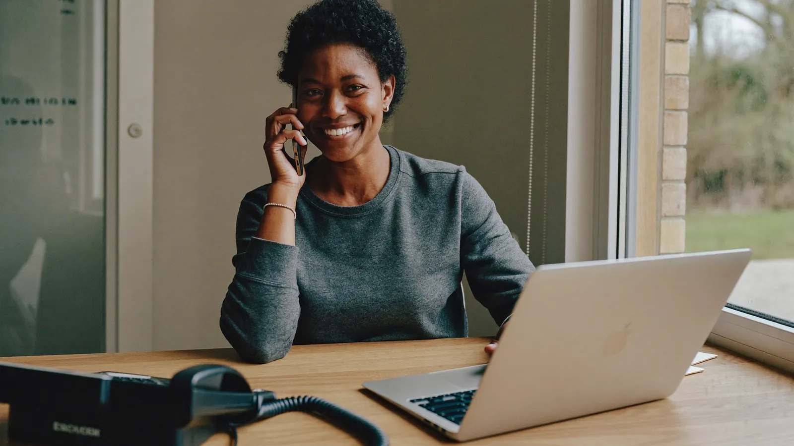 A recruitment consultant on a phone call at her desk